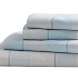 A set of light blue and white plaid bed sheets is neatly folded. The stack includes pillowcases and sheets with a subtle checkered pattern.