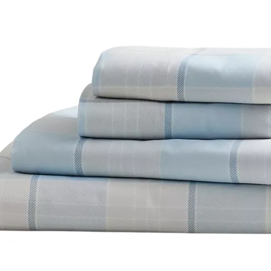A set of light blue and white plaid bed sheets is neatly folded. The stack includes pillowcases and sheets with a subtle checkered pattern.