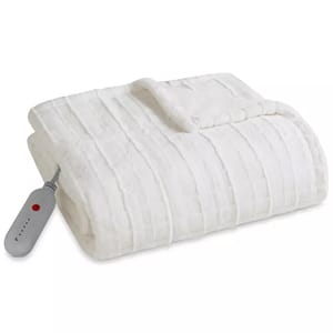 A white Sharper Image heated throw with a striped pattern and an attached remote control for adjusting heat settings.