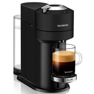 The Nespresso Vertuo Espresso Machine in black features a water reservoir, a sleek design, and is shown brewing coffee into a clear glass mug with a thick crema layer.