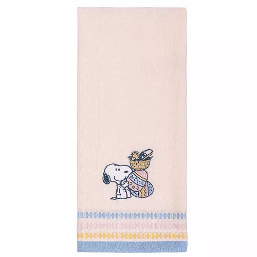 A beige hand towel featuring a cartoon dog carrying a basket of decorated eggs, with blue and yellow accents along the bottom.