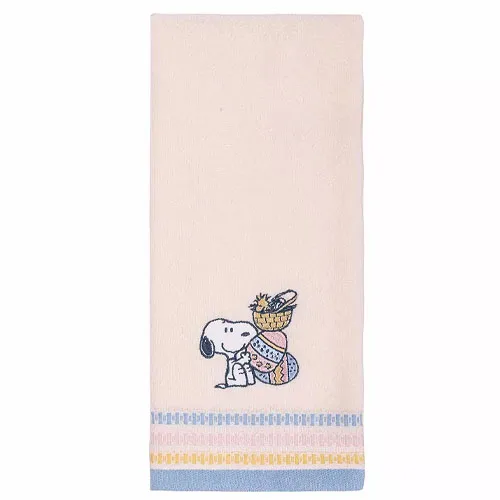 A beige hand towel featuring a cartoon dog carrying a basket of decorated eggs, with blue and yellow accents along the bottom.