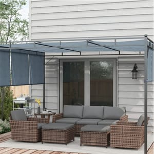 Outdoor patio set with cushioned sectional sofa and chairs, a pergola with retractable canopy, and hanging wall lantern.