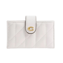 A white quilted wallet features a gold letter \“C\“ on the snap closure tab.