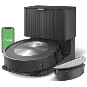 Refurbished iRobot Roomba with an automatic emptying base and a detachable cleaning pad, shown with smartphone app compatibility indicated by the iRobot app on a nearby phone screen.