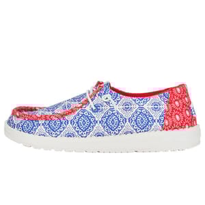 Hey Dude Americana Shoes feature a red, white, and blue patterned design with lace-up fronts. They have a white sole and are lightweight, ideal for casual wear.