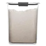 A clear rectangular container with a black handle on the lid, filled with a white powdery substance, possibly flour or sugar.