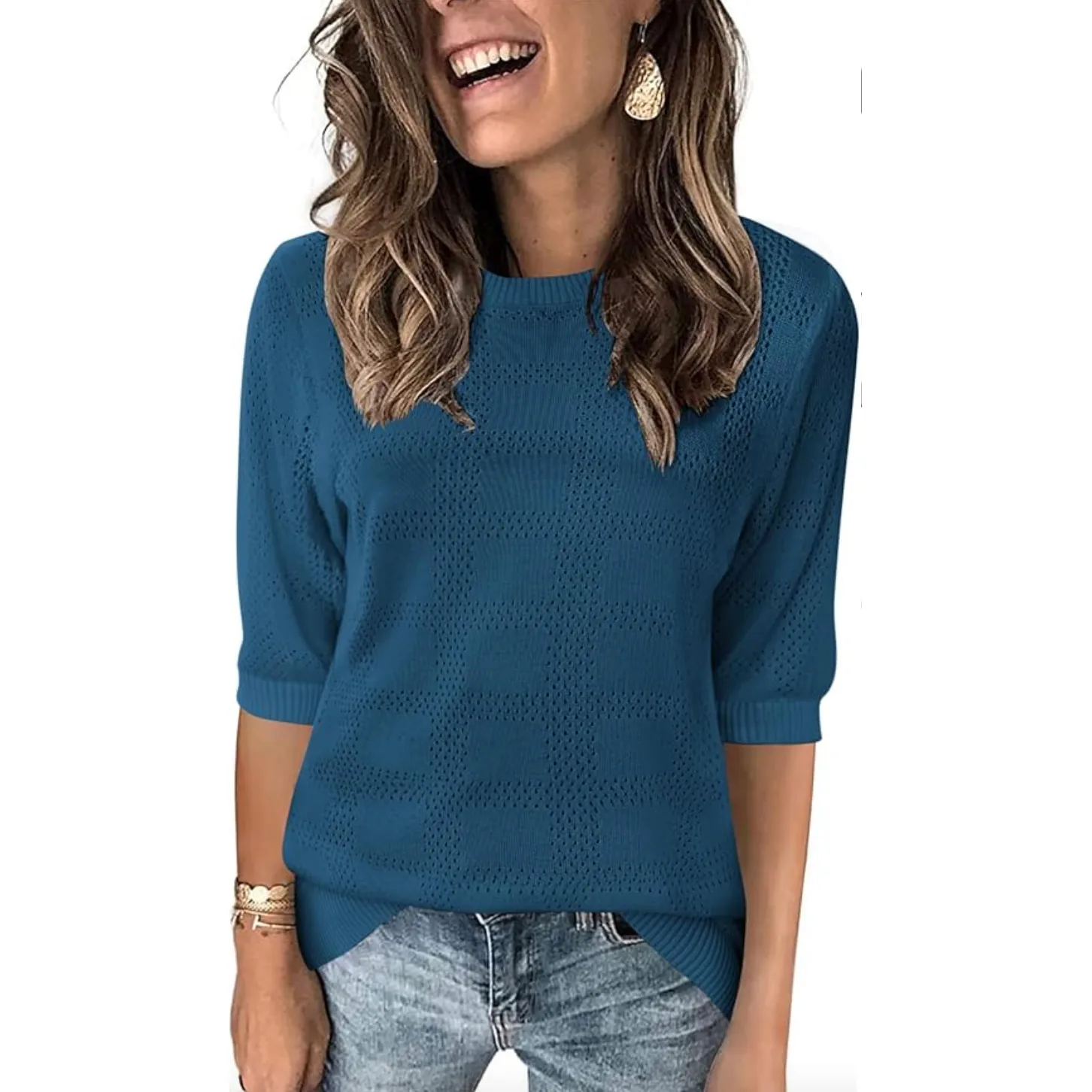 Teal knit pullover with a textured square pattern, featuring three-quarter sleeves and a relaxed fit. Suitable for casual wear, paired with jeans and accessorized with simple jewelry.