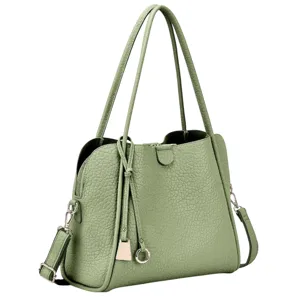 A light green handbag made of textured material with long shoulder straps and metal hardware, including a decorative tassel and adjustable strap.