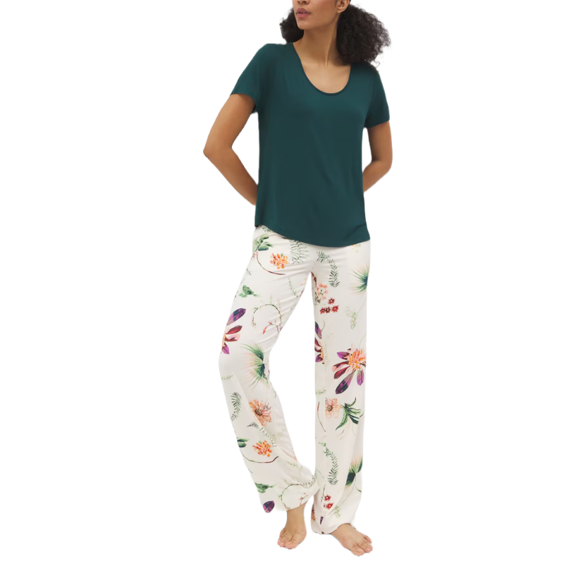 A pajama set featuring a short-sleeve, dark green top and white pants with a colorful floral print. The pants have a relaxed fit, suitable for a comfortable lounging experience.