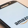 an image of a cell phone displaying the amazon app on a beige background