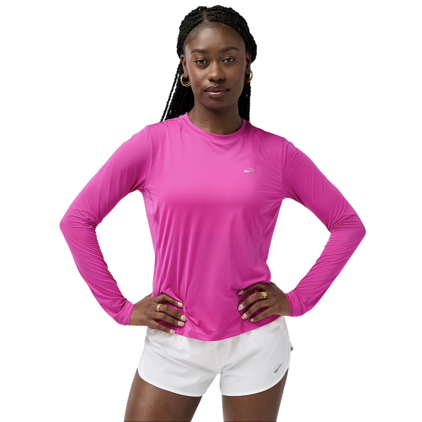A person wearing a pink long-sleeve athletic top with a small logo, paired with white shorts.