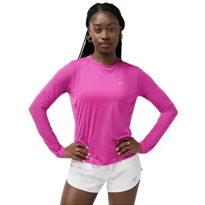 A person wearing a pink long-sleeve athletic top with a small logo, paired with white shorts.