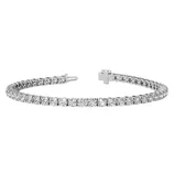 A tennis bracelet featuring a series of round, clear gemstones set in a sleek metal band with a secure clasp.