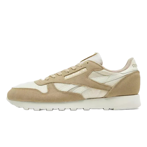 Tan and white Reebok Classic sneakers featuring a suede and mesh upper, with the Reebok logo on the side and a textured white sole.