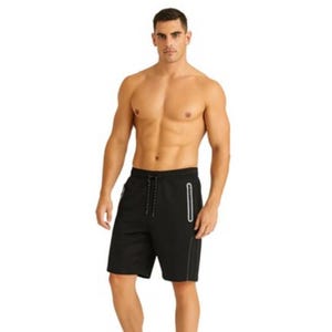 Man in black athletic shorts with a drawstring waist and vertical side zippers, standing shirtless.