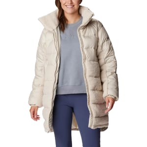 Woman wearing a beige and cream Columbia jacket with a hood, a gray sweatshirt, and blue leggings.