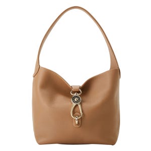 A tan leather hobo bag with a single strap and gold-tone hardware, featuring a decorative clasp detail.