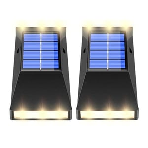 2-pack of solar LED wall lights with a sloped black design, featuring prominent solar panels on top and multiple small lights emitting warm illumination on the front.