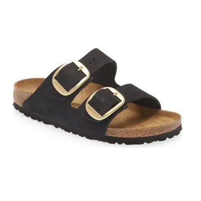 Black sandal with two adjustable straps and gold-toned buckles, featuring a cork footbed and black sole.