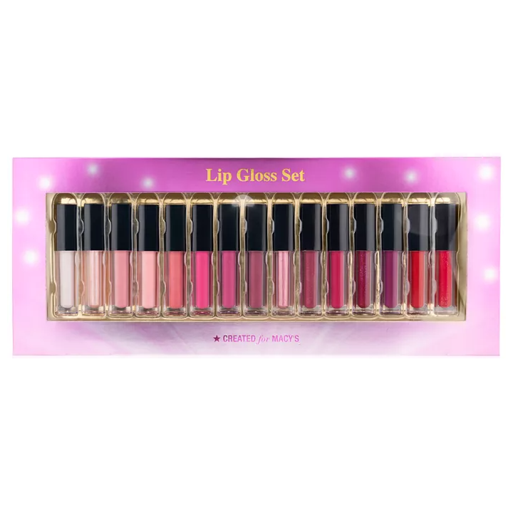 A 15-piece lip gloss set featuring a variety of shades ranging from light pinks and nudes to deeper reds and purples. The set is presented in a pink and gold box with \“Lip Gloss Set\“ and \“Created for Macy's\“ on the packaging.