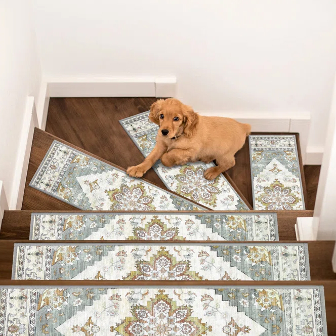 A small dog lies on a wooden staircase adorned with decorative stair runners featuring a floral and geometric pattern in soft blue, green, and beige colors.