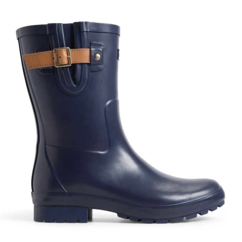 A navy blue mid-calf rubber rain boot with a textured sole and brown buckle strap detail around the top.