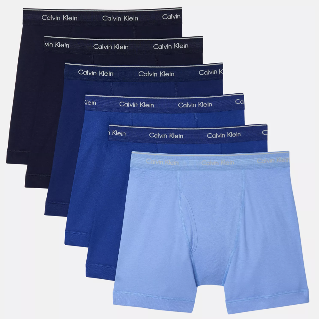 A set of five Calvin Klein men's boxer briefs in various shades of blue, each featuring a branded waistband.