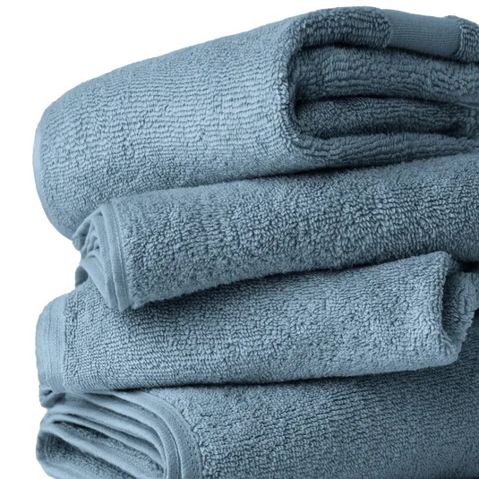 A stack of folded, light blue towels, showcasing a soft and textured surface.