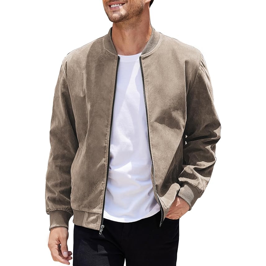 A man wearing a beige suede bomber jacket over a white t-shirt paired with black pants.