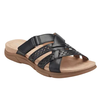 A black slide sandal with a perforated strap design and cushioned tan footbed, featuring a durable brown sole.