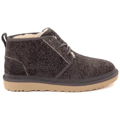 A fuzzy, dark-colored ankle boot with lace-up closure, a tan rubber sole, and a loop at the back, lined with cream-colored shearling.