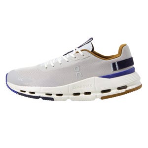 A white athletic shoe with brown and blue accents, featuring the On logo and CloudTec cushioning.