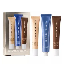 Summer Fridays The Holiday Trio includes three tubes: Butter Balm in vanilla beige and brown packaging, and Jet Lag Mask in blue.