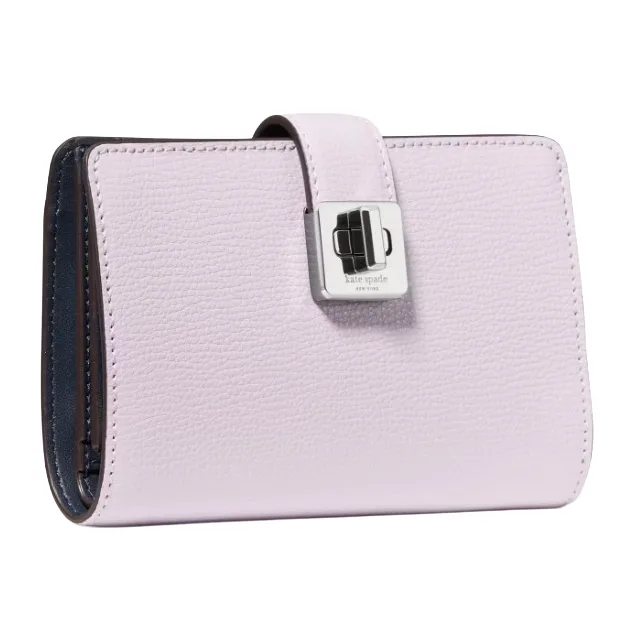 A lavender leather wallet with a silver-tone clasp, featuring a logo that reads \“kate spade new york.\“