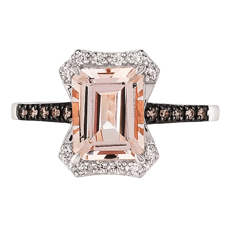 A rectangular morganite gemstone ring set in a white metal with a diamond halo and a band accented with smaller stones.