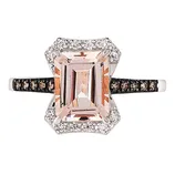 A rectangular morganite gemstone ring set in a white metal with a diamond halo and a band accented with smaller stones.