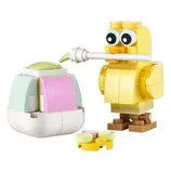 Yellow brick-built bird with googly eyes interacting with a colorful brick-built object, possibly an egg with a pastel color scheme, featuring detachable elements.