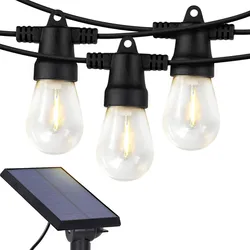 Solar-powered patio string lights featuring bulbs with filament-style illumination and a sleek black cable. An attached solar panel provides energy, making them ideal for outdoor use without electrical outlets.