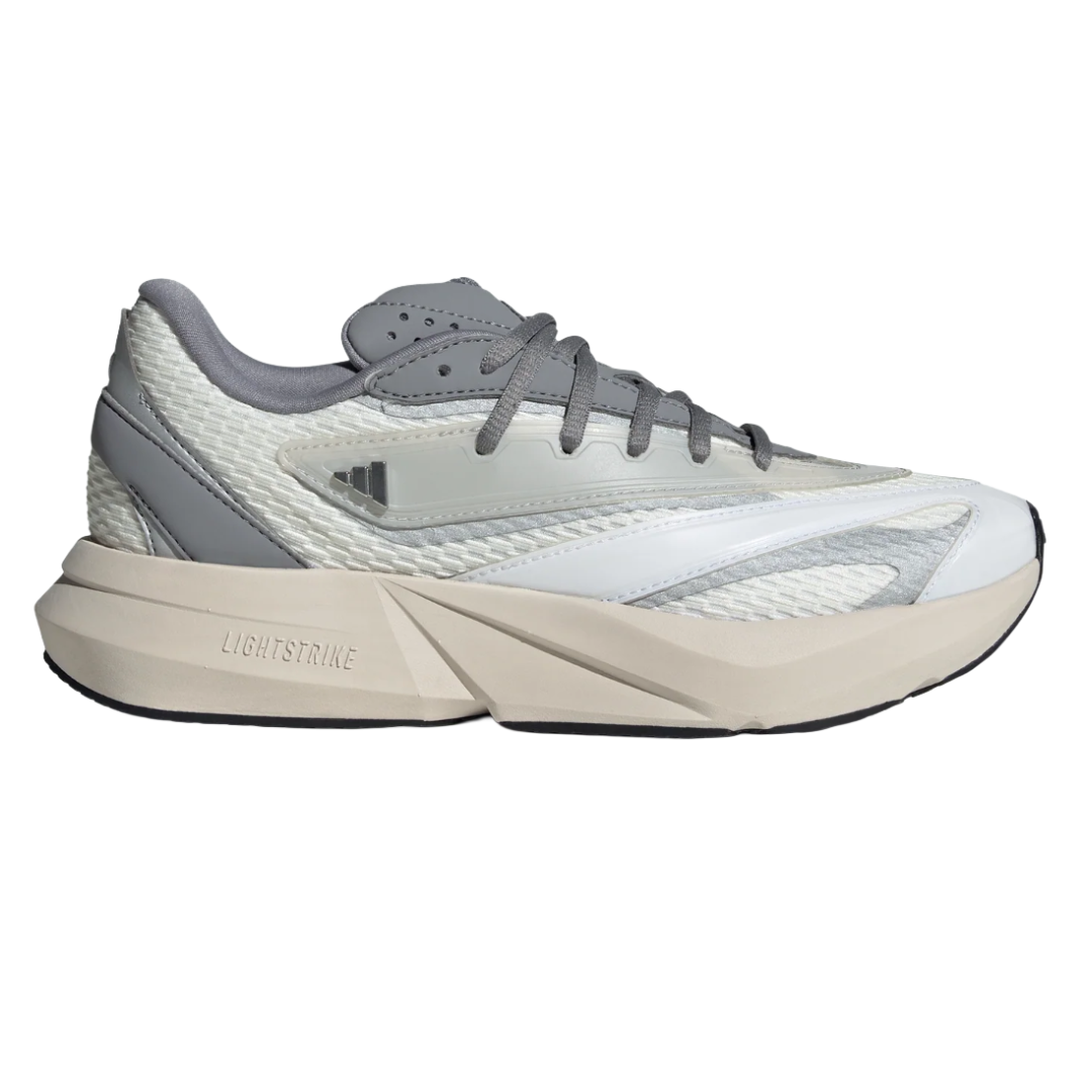 A grey and white sneaker with a chunky sole featuring \“Lightstrike\“ cushioning technology. It has a textured upper with mixed materials and lace-up closure.