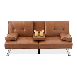 A brown leather-look futon sofa with adjustable armrests and a center tray featuring two cup holders with drinks, supported by shiny metal legs.