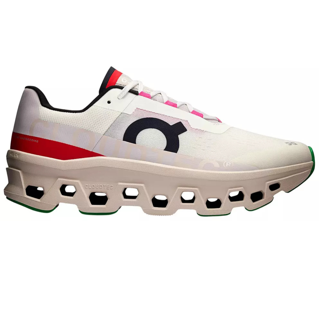 White and red athletic shoe featuring a distinctive honeycomb-patterned sole with \“CloudTec\“ technology, branding on the side, and black and green accents.