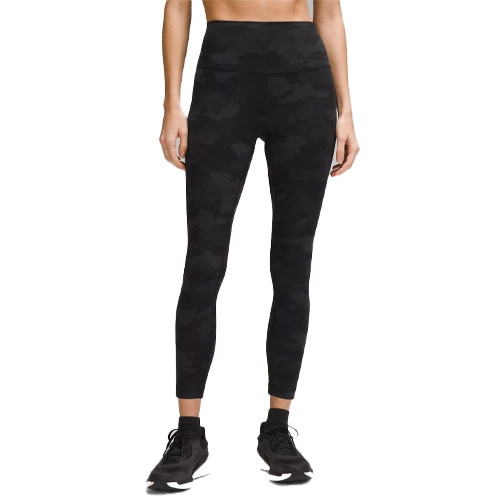 Black camo high-waisted leggings paired with black sneakers.