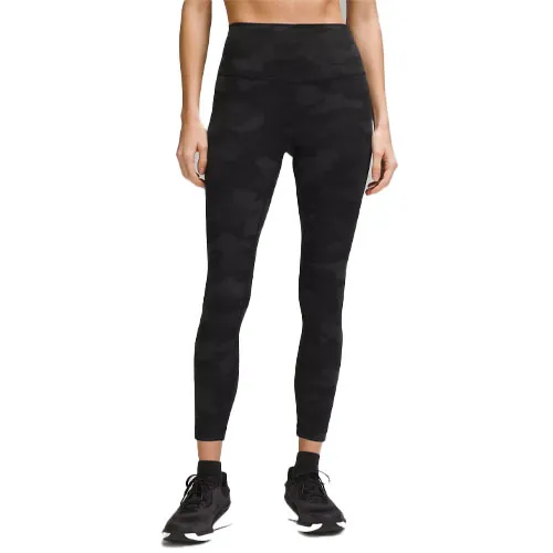 Black camo high-waisted leggings paired with black sneakers.