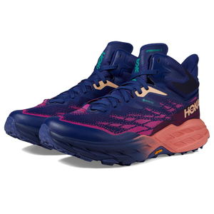 A pair of high-top, navy blue Hoka Speedgoat 5 GTX trail running shoes featuring pink pixelated patterns and orange accents.