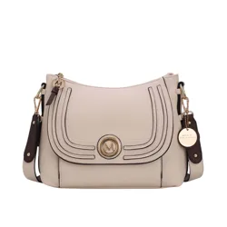 A beige crossbody handbag with dark brown accents and gold hardware, featuring a decorative \“M\“ emblem and a detachable shoulder strap.