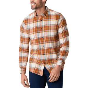 A man is wearing a long-sleeved plaid flannel shirt with hues of orange, yellow, and white, accented with blue pants.