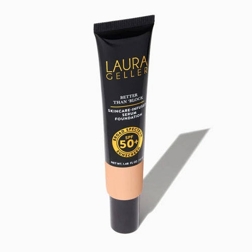 Black tube of Laura Geller foundation with peach-colored label, offering SPF 50 protection and skincare-infused benefits.