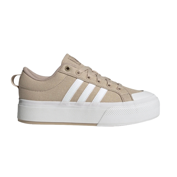 Beige low-top sneaker with a thick white sole and three white stripes on the side.