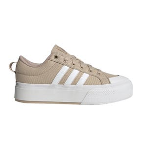 Beige low-top sneaker with a thick white sole and three white stripes on the side.